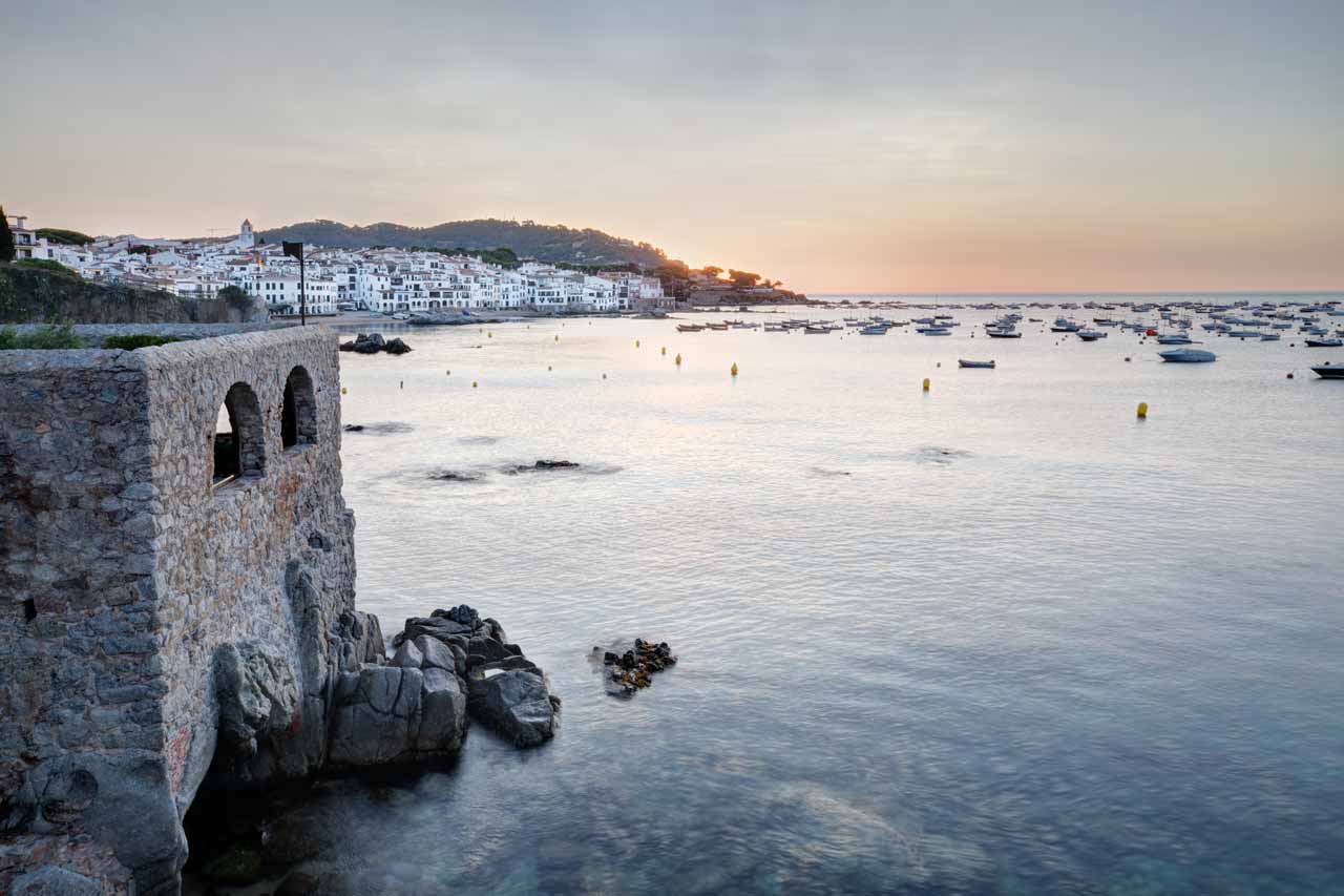 Sunrise behind a full view of the Calella of Palafrugell Village, in la Costa Brava